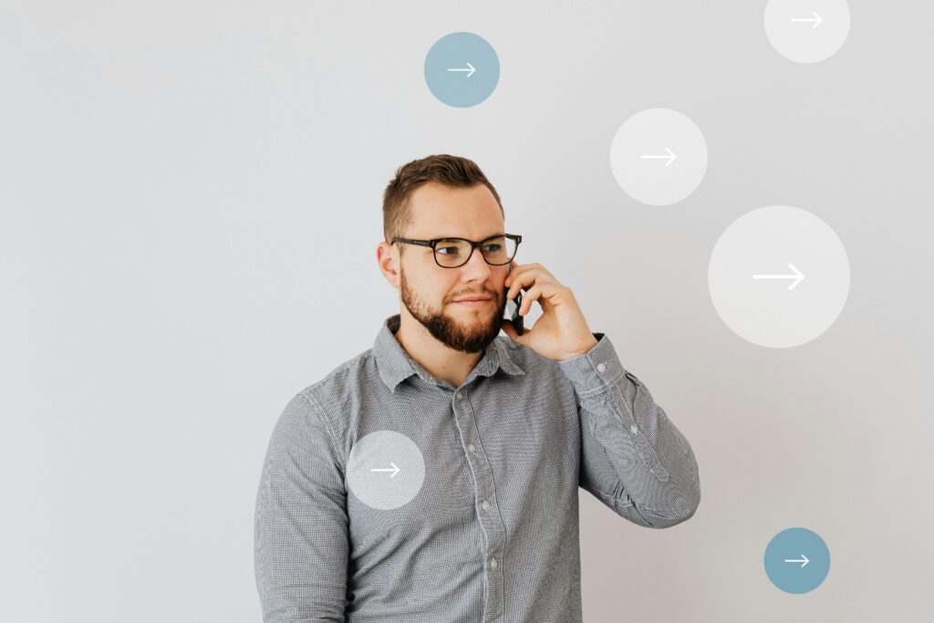 Professional man talking on smartphone with overlay arrow graphics, symbolizing communication.